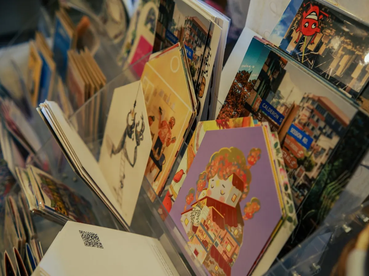 Illustrated postcards and art cards on a shop display rack