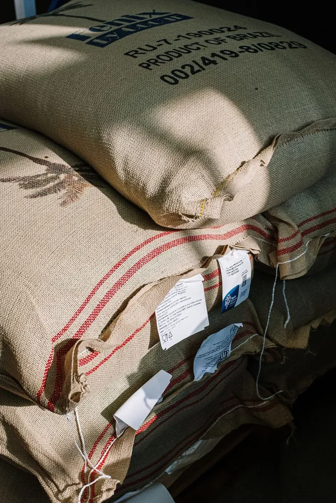 Freshly roasted coffee beans spilling from a paper bag