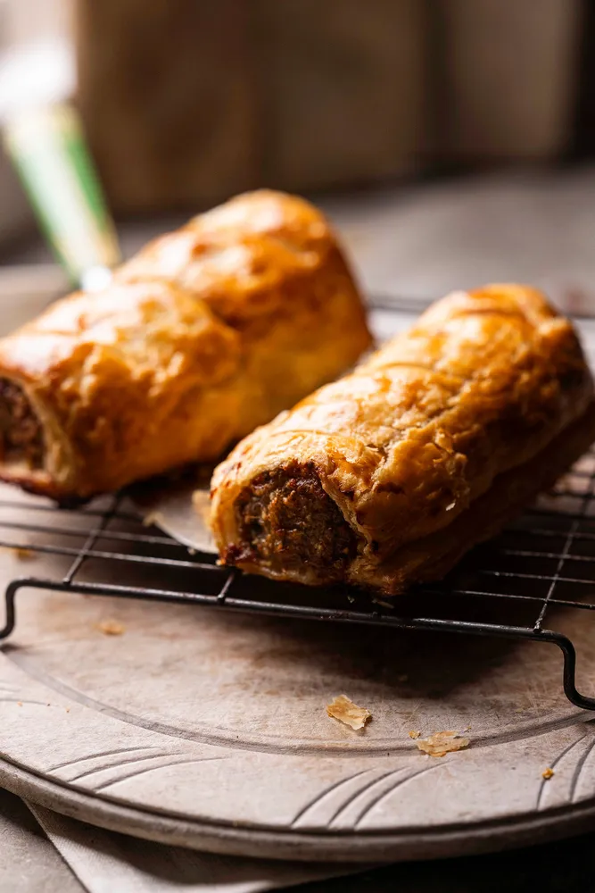 Golden sausage rolls on a board