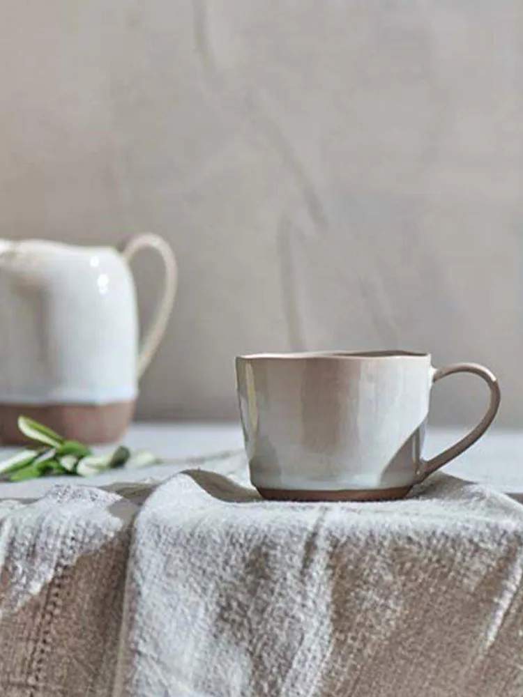 Two Nkuku Edo terracotta mugs with off-white glaze