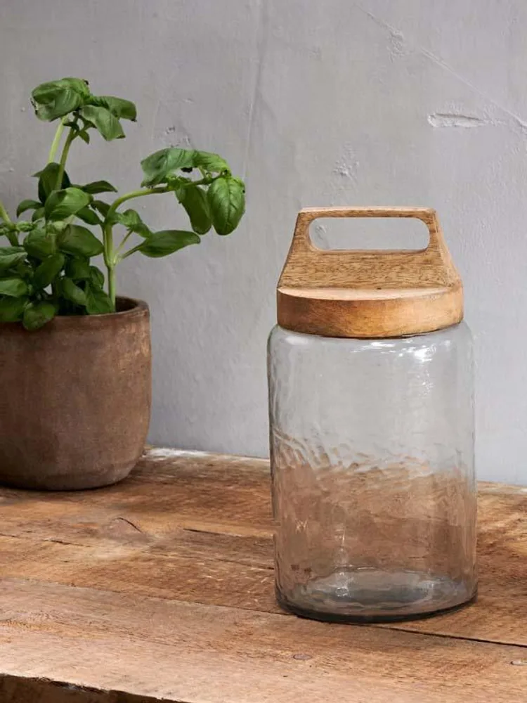 A Nkuku Kitto recycled glass storage jar with wooden lid