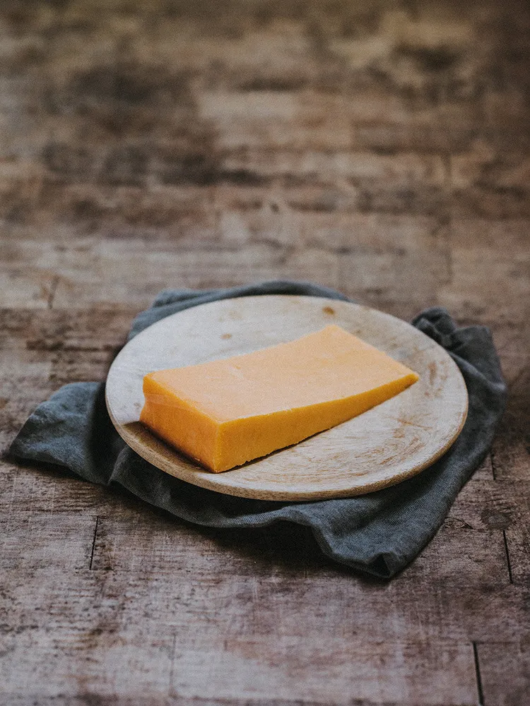 Quicke's Double Devonshire clothbound cheese wedge
